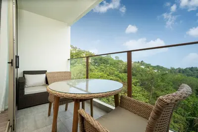 a balcony with a table and chairs and a view at Prime Location Kamala Ocean View Suite OCN C64 just 450m to the Beach in Kamala Beach