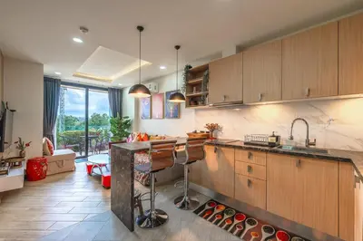 a kitchen with a sink and a counter with a bar at C214 Condo Seaview Pools Gym Walk to Rawai Beach in Rawai Beach