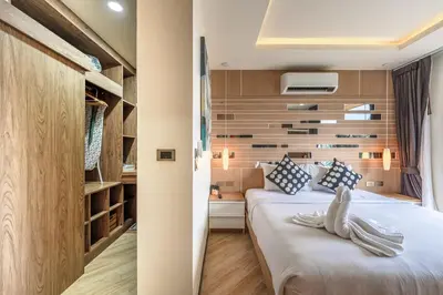 a hotel room with two beds and a closet at C214 Condo Seaview Pools Gym Walk to Rawai Beach in Rawai Beach