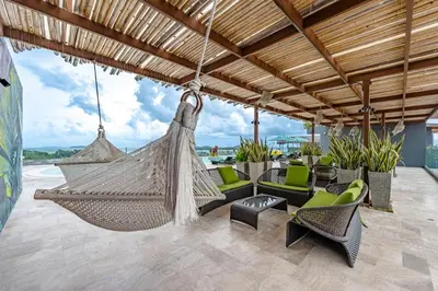 a hammock on the patio of a resort at C214 Condo Seaview Pools Gym Walk to Rawai Beach in Rawai Beach