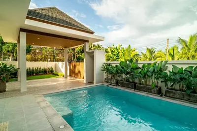 a swimming pool in the backyard of a house at Narinsaya Pool villas in Nai Yang Beach