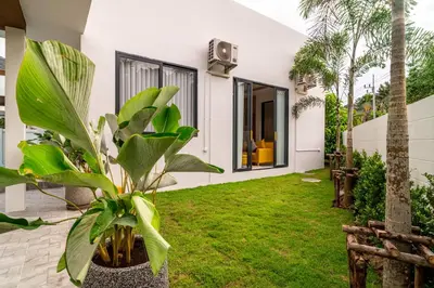 a garden view of a house with plants at Narinsaya Pool villas in Nai Yang Beach