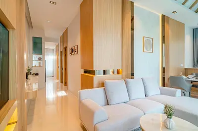 a living room with a white couch and a table at Narinsaya Pool villas in Nai Yang Beach