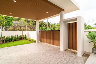 a patio with a brown door in a house at Narinsaya Pool villas in Nai Yang Beach