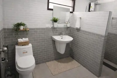 a bathroom with a white toilet and a sink at Villa Lilly in Rawai Beach