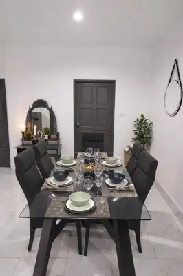 a dining room table with plates and wine glasses at Villa Lilly in Rawai Beach