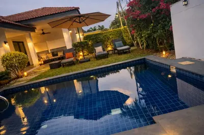 a swimming pool in the backyard of a house at Villa Lilly in Rawai Beach