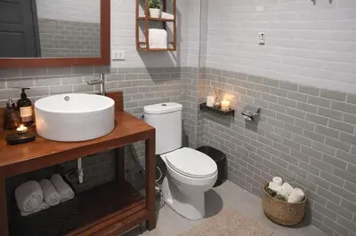 a bathroom with a white toilet and a sink at Villa Lilly in Rawai Beach