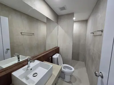 a bathroom with a sink and a toilet and a mirror at Hommory Residence - Phuket Town in Ban Lo Long