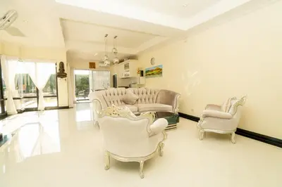 a living room with white chairs and a table at Laguna Luxure Private Pool Villa in Layan Beach