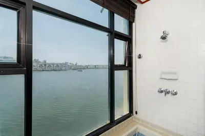 a bathroom with a window with a view of the water at Allamanda Townhouse Laguna Phuket Bang Tao Beach in Laguna Phuket