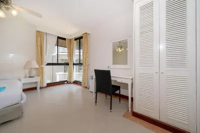 a room with a desk and a bed and a bedroom at Allamanda Townhouse Laguna Phuket Bang Tao Beach in Laguna Phuket
