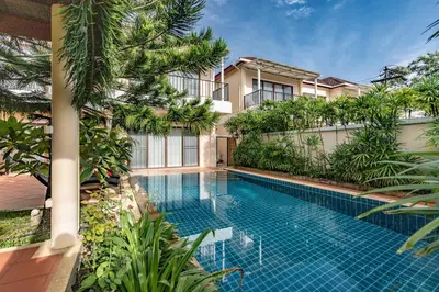 a swimming pool in front of a building at Villa Belloro Bang Tao 3BR East Residence in Ban Pak Lak