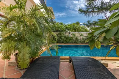 a swimming pool with a bench next to a house at Villa Belloro Bang Tao 3BR East Residence in Ban Pak Lak