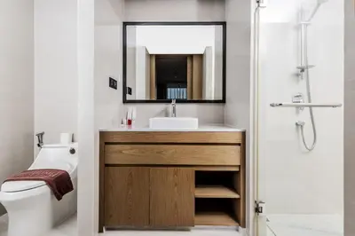 a bathroom with a sink and a mirror at Suite Aura 1BR PoolsGyms Shuttle to Nai Harn in Rawai Beach