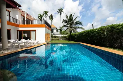 a swimming pool in front of a villa at Villa Elara Bang Tao 3BR Pool East Residence in Ban Pak Lak