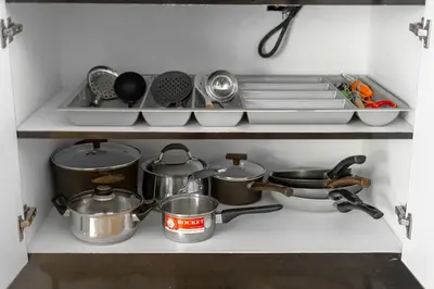 a kitchen with pots and pans on a shelf at Villa Elara Bang Tao 3BR Pool East Residence in Ban Pak Lak