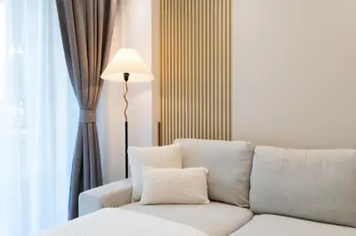 a living room with a white couch and a lamp at Suite Coral 2BR Pool AccessReLife Nai Harn in Phuket Town