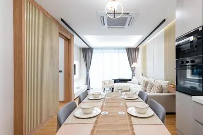 a living room with a long table and chairs at Suite Coral 2BR Pool AccessReLife Nai Harn in Phuket Town