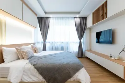 a bedroom with a bed and a large window at Suite Coral 2BR Pool AccessReLife Nai Harn in Phuket Town