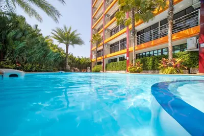 a swimming pool in front of a building at ARIA Condo 1BR Pool View NBC Nai Harn in Phuket Town
