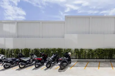 a row of motorcycles parked in a parking lot at Suite Verda 1BR Garden View Fantasea Kamala in Phuket Town