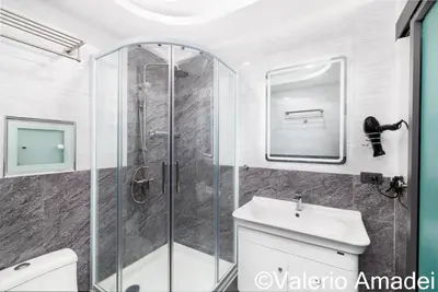 a bathroom with a shower and a toilet and a sink at OMNIAPHUKET - Patong Tower - Premium 3 Bedrooms Apartment in Patong Beach