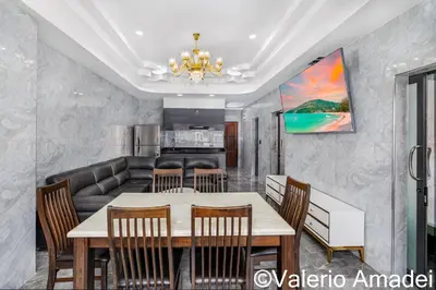 a dining room with a table and chairs at OMNIAPHUKET - Patong Tower - Premium 3 Bedrooms Apartment in Patong Beach