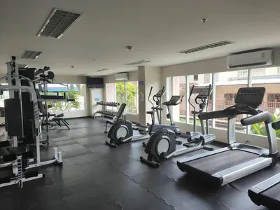 a gym with several treadmills and elliptical machines at OMNIAPHUKET - Patong Center Pool Gym Near Bangla Road in Patong Beach