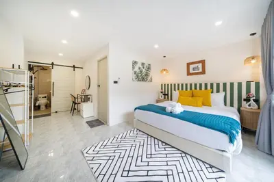 a bedroom with a large bed and a bathroom at Wink 3 Patong Beach Phuket sleep 8 in Patong Beach