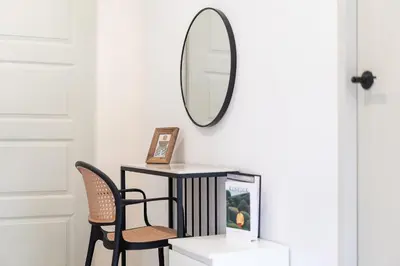 a mirror on a wall above a table with a chair at Wink 3 Patong Beach Phuket sleep 8 in Patong Beach