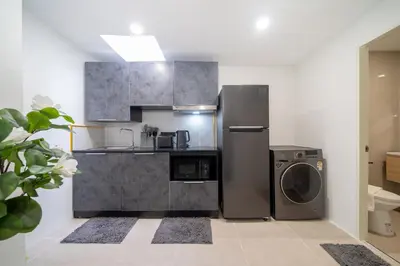 a kitchen with a refrigerator and a washing machine at Wink 3 Patong Beach Phuket sleep 8 in Patong Beach