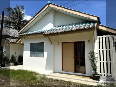 a small white house with a gate at Home Hug local stay Bangtao in Bang Tao Beach