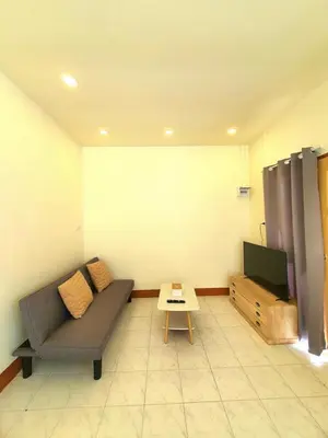 a living room with a couch and a tv at Home Hug local stay Bangtao in Bang Tao Beach