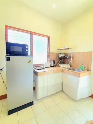 a small kitchen with a refrigerator and a counter at Home Hug local stay Bangtao in Bang Tao Beach