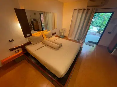 a large bed in a room with a window at Leon Oasis Nai Harn in Rawai Beach