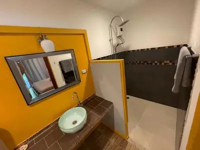 a bathroom with a sink and a mirror at Leon Oasis Nai Harn in Rawai Beach