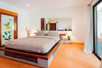 a bedroom with a bed in a room at Leon Oasis Nai Harn in Rawai Beach