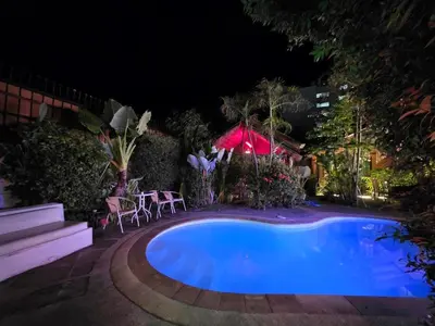 a large blue swimming pool at night at Leon Oasis Nai Harn in Rawai Beach
