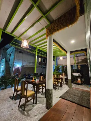 an outdoor patio with a table and chairs at Little Green House in Ao Nang Beach