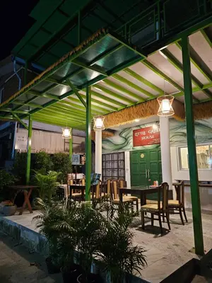 a patio with a table and chairs under awning at Little Green House in Ao Nang Beach
