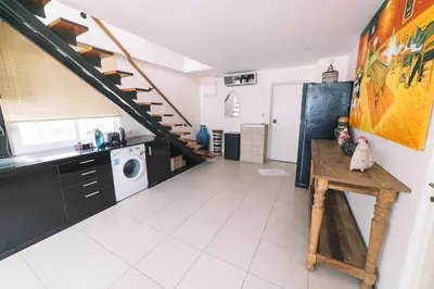a kitchen with a staircase and a washing machine at Patong Condotel Penthouse 2 bedroom in Patong Beach