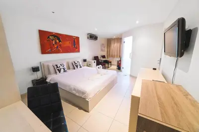 a hotel room with a bed and a television at Patong Condotel Penthouse 2 bedroom in Patong Beach
