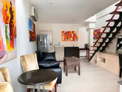 a living room with a couch and a table at Patong Penthouse 1 bedroom in Patong Beach