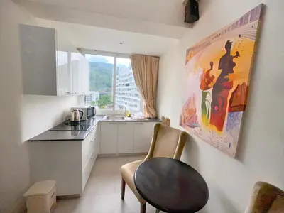a kitchen with a counter and a chair in a room at Patong Penthouse 1 bedroom in Patong Beach