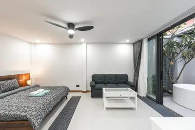 a living room with a couch and a ceiling fan at V215 ChaoFah Oasis Private Pool & Garden Retreat in Phuket Town