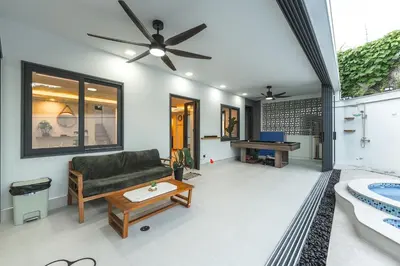a living room with a couch and a table at V215 ChaoFah Oasis Private Pool & Garden Retreat in Phuket Town
