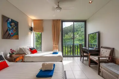 a bedroom with two beds and a desk and a balcony at C215 Pool View 2BR and 200m to Beach Prime Location in Surin Beach