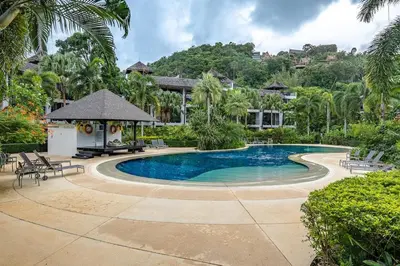 a swimming pool in front of a house at C215 Pool View 2BR and 200m to Beach Prime Location in Surin Beach