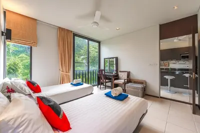 a hotel room with two beds and a kitchen at C215 Pool View 2BR and 200m to Beach Prime Location in Surin Beach